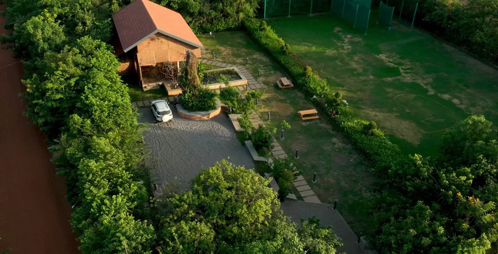 Aerial view of tree-lined plots and roads at Woods Shamshabad
