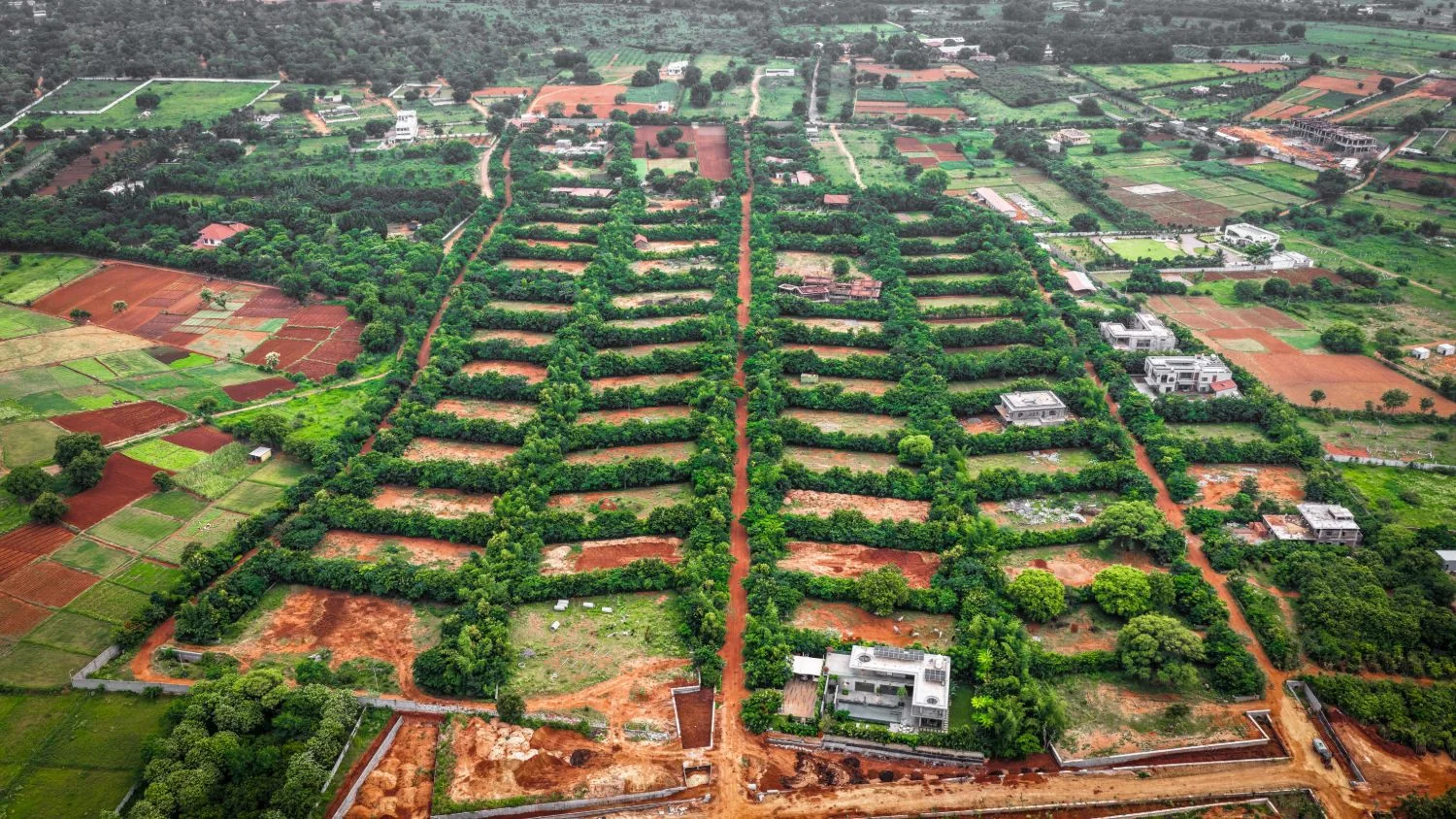 Aerial view of tree-lined plots and roads at Woods Shamshabad